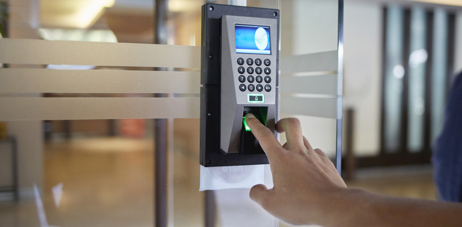 index finger placing on a biometric attendance system