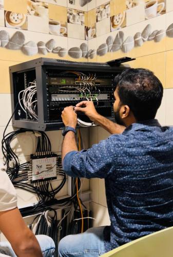 technician fixing cables in the switch